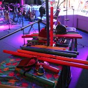 Since we were there before the crowds, Randy took the opportunity for a quick photo tour of the stage. Of course, boomwhackers, helmets, hats, vibraslaps, deskbells, castinets, noseflutes, Velcro everywhere – they are back at it with additional creativity!   (photo by Randy Brown)